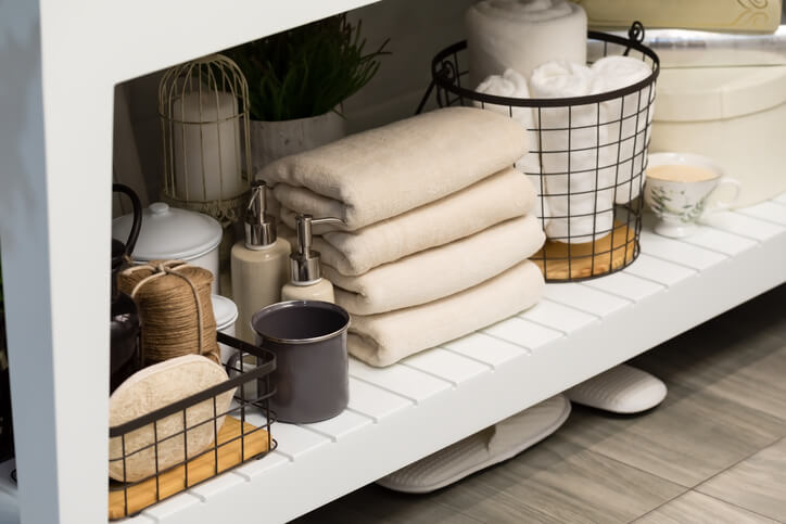 Bath towels stored on shelves of a clutterfree bathroom