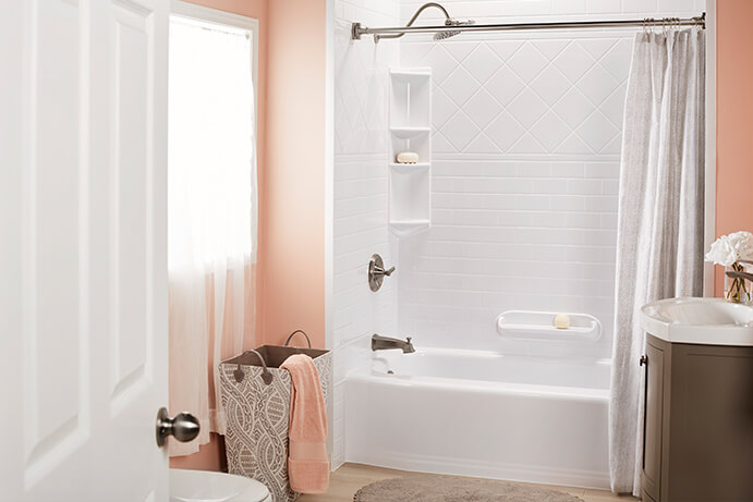 Bathroom with pink walls and white tub