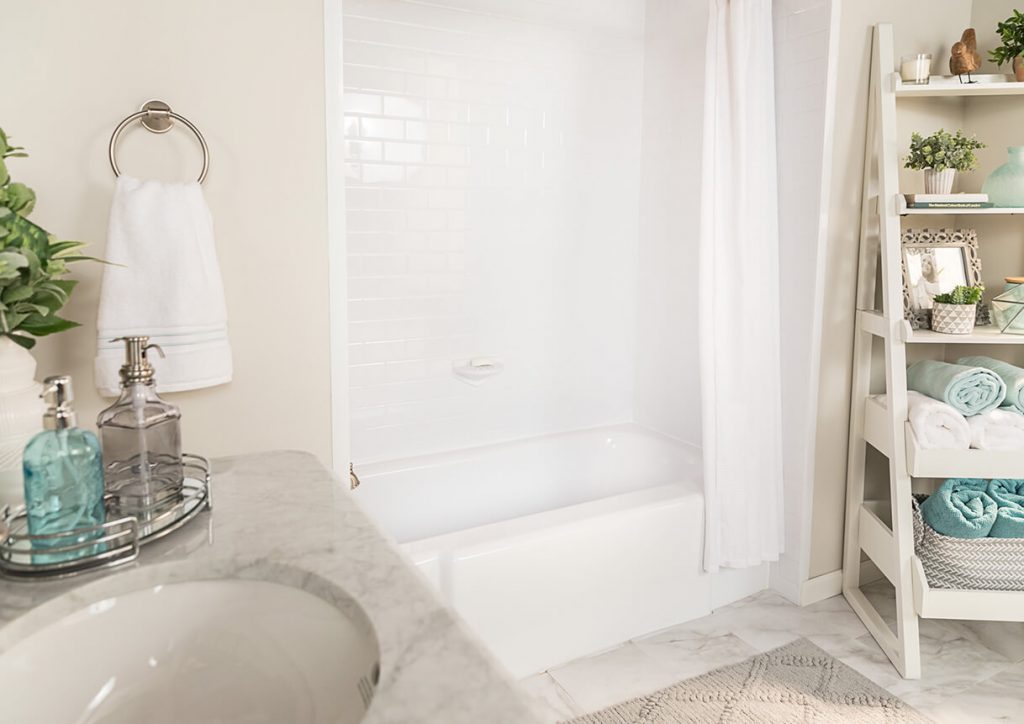 Neutral bathroom with white bath and towels