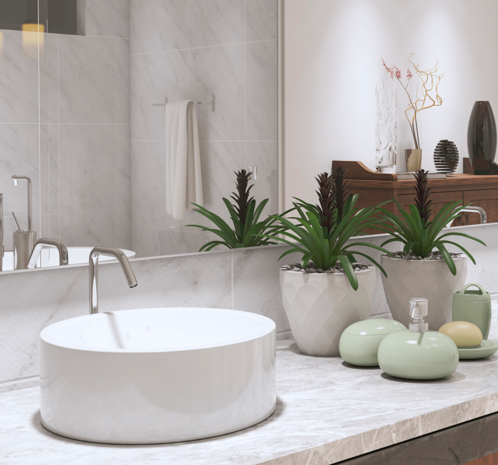 marble vanity with two circular sinks divided by a display of plants and soap dishes