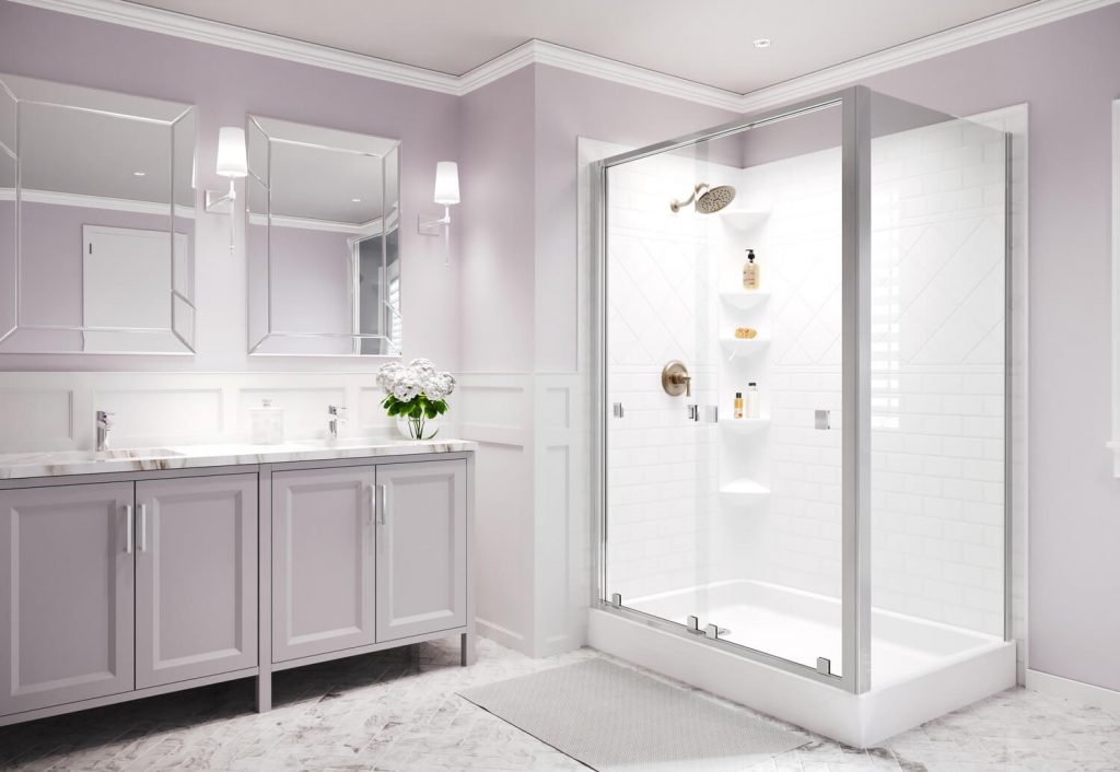 A light and airy bathroom with a shower is lit by both sconces and recessed ceiling lights.