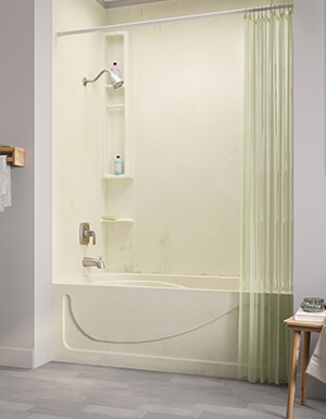 A fiberglass bathtub is the focus of a grey bathroom