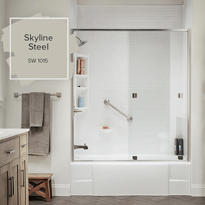 A white marbled shower is on display in a taupe colored bathroom