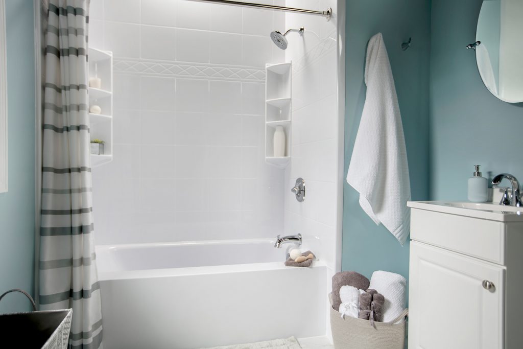 Small bathroom with a white Bath Fitter bathtub and wall solution.