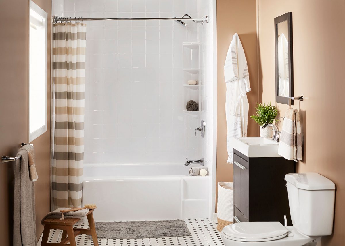 Bathroom with a white Bath Fitter tub and acrylic wall