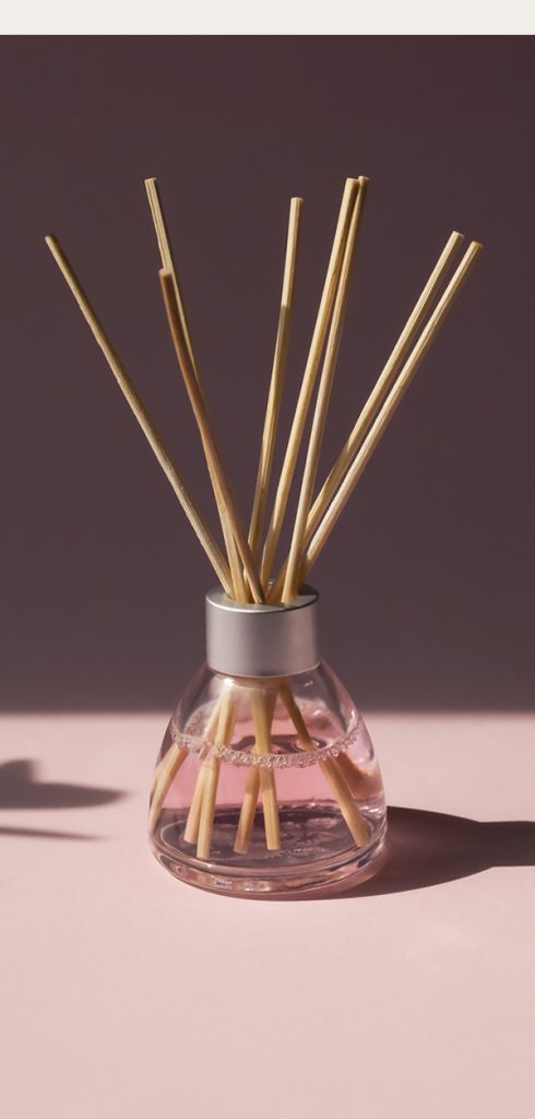 Aromatic air freshner stick in a small glass pot